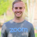 man smiling wearing a zoom shirt